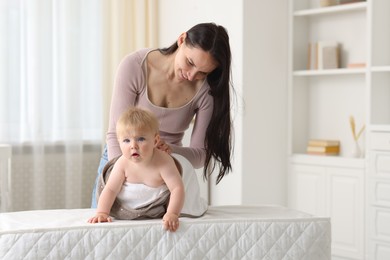 Photo of Mother with her cute baby at home