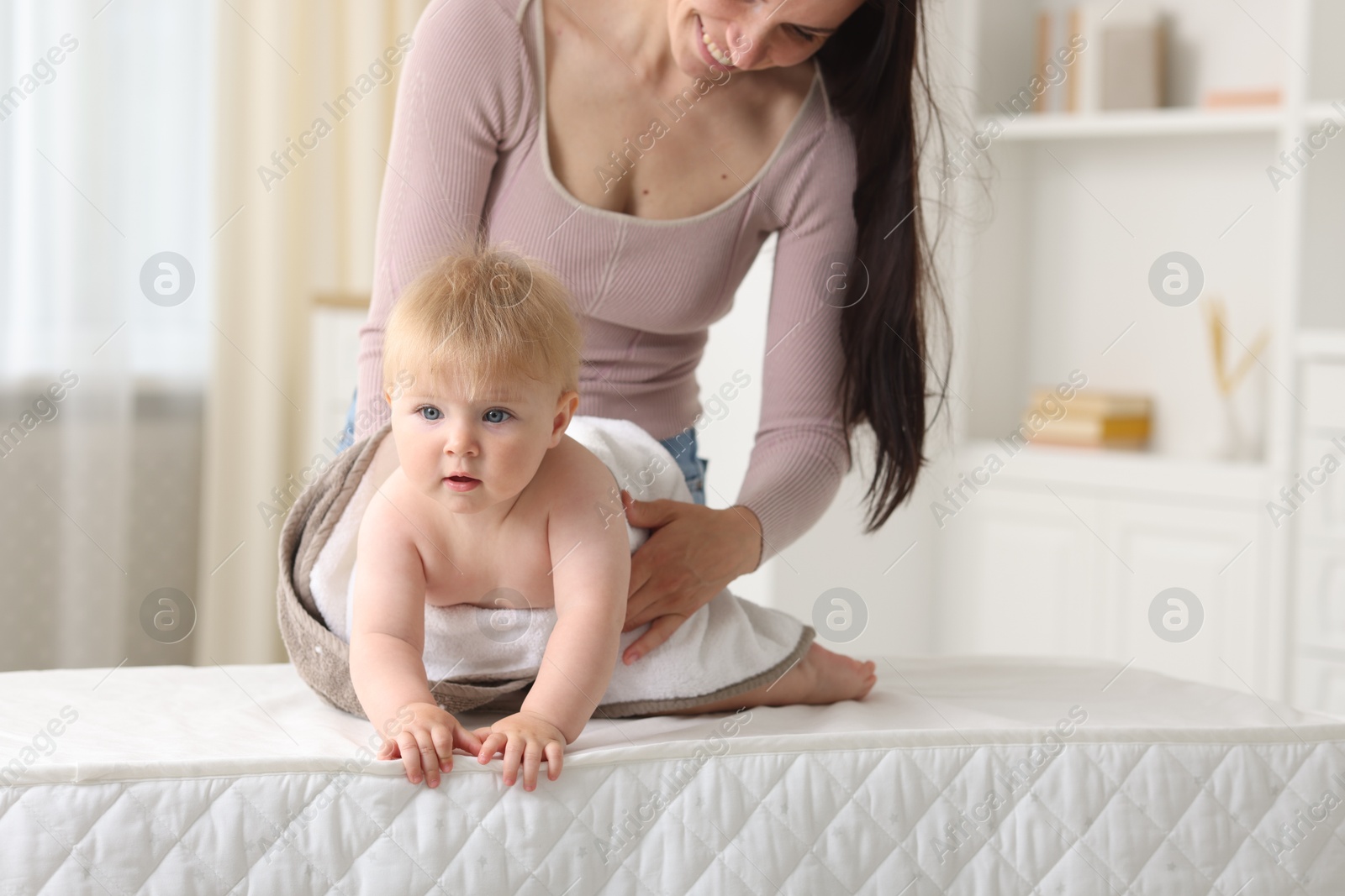 Photo of Mother with her cute baby at home, closeup