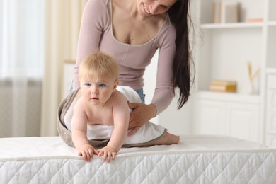 Photo of Mother with her cute baby at home, closeup