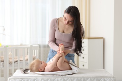 Photo of Mother with her cute baby at home