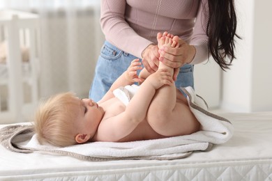 Photo of Mother with her cute baby at home, closeup