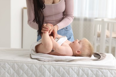 Photo of Mother with her cute baby at home, closeup