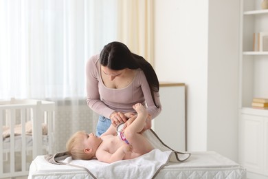 Photo of Mother with her cute baby at home, space for text