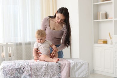 Photo of Mother with her cute baby at home