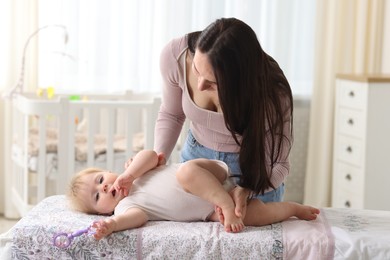 Photo of Mother with her cute baby at home