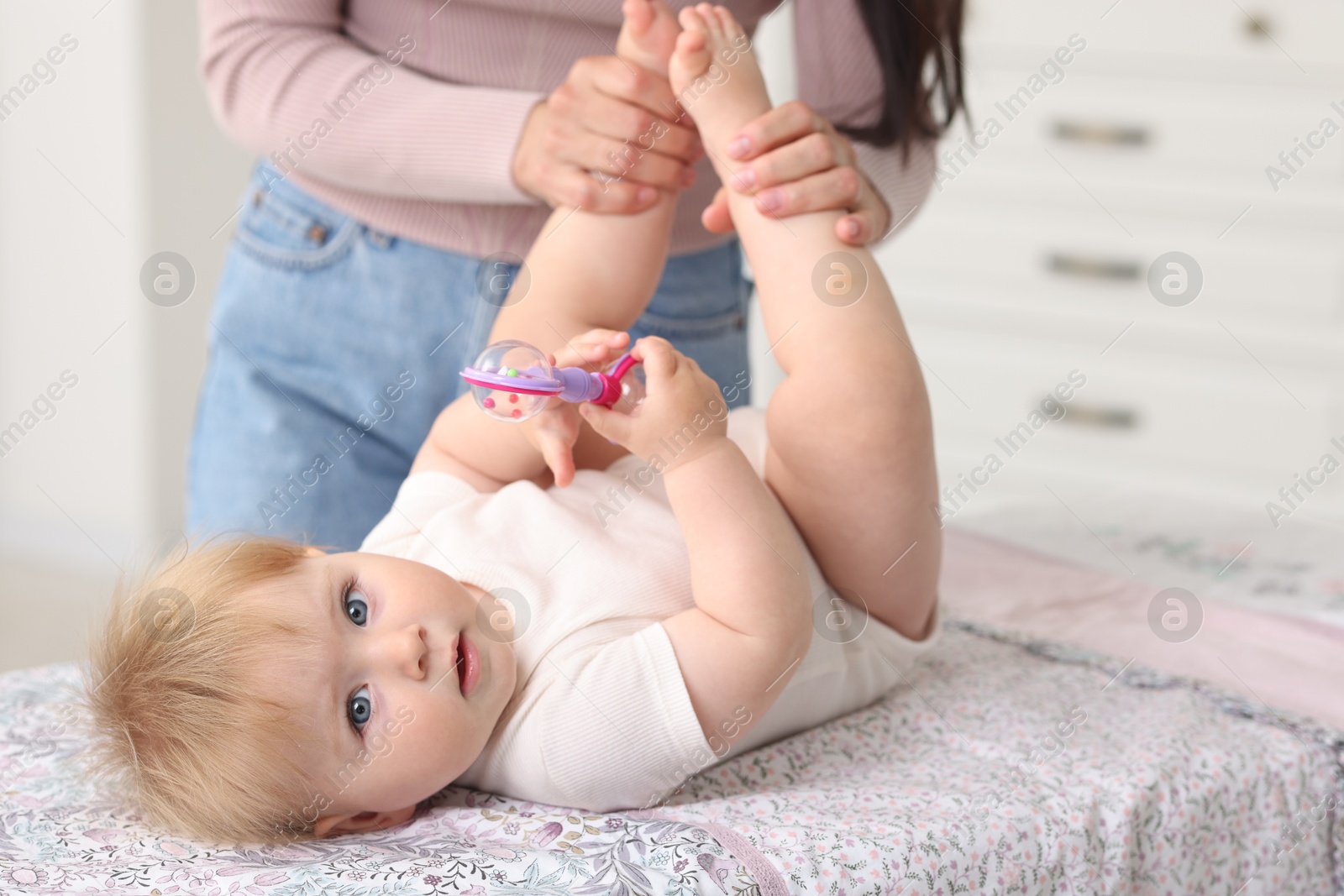 Photo of Mother with her cute baby at home, closeup