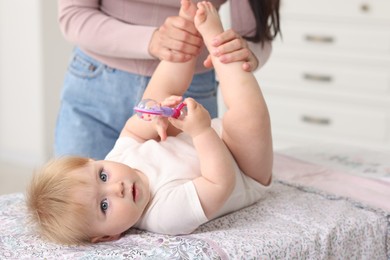 Photo of Mother with her cute baby at home, closeup