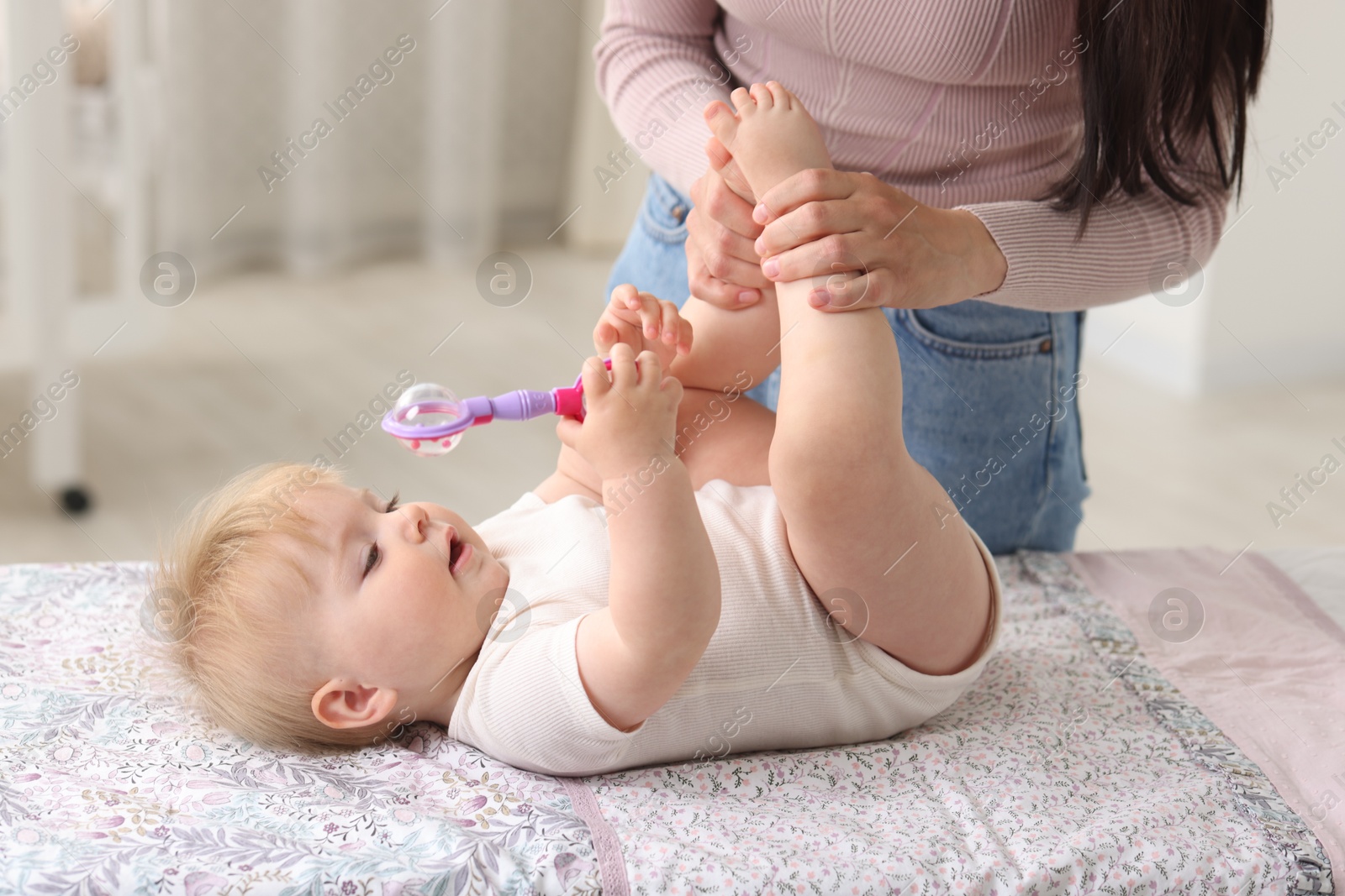Mother with her cute baby at home, closeup Photo of Mother with her cute baby at home, closeup