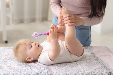 Photo of Mother with her cute baby at home, closeup