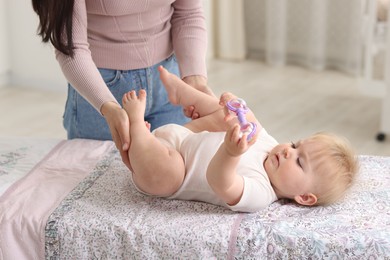 Photo of Mother with her cute baby at home, closeup