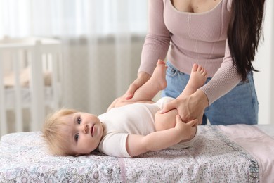 Photo of Mother with her cute baby at home, closeup