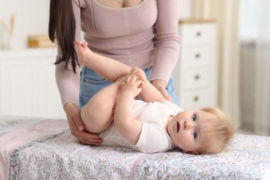 Photo of Mother with her cute baby at home, closeup