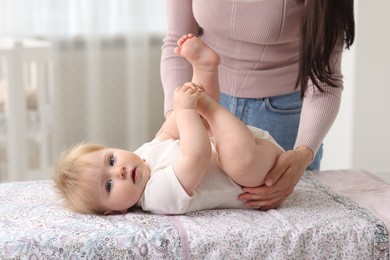 Photo of Mother with her cute baby at home, closeup