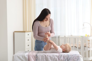 Photo of Mother with her cute baby at home