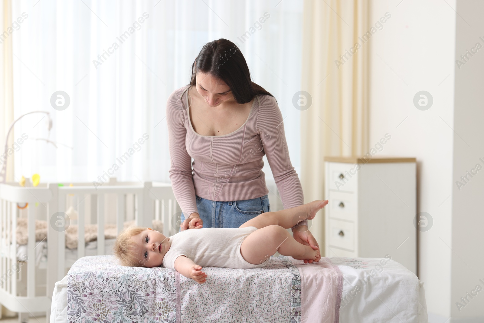 Photo of Mother with her cute baby at home
