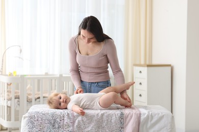 Photo of Mother with her cute baby at home