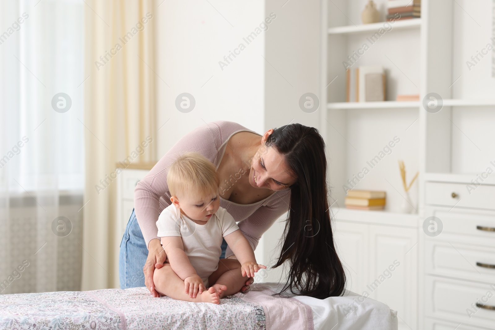 Photo of Mother with her cute baby at home