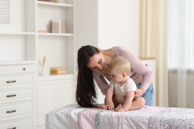 Photo of Mother with her cute baby at home, space for text