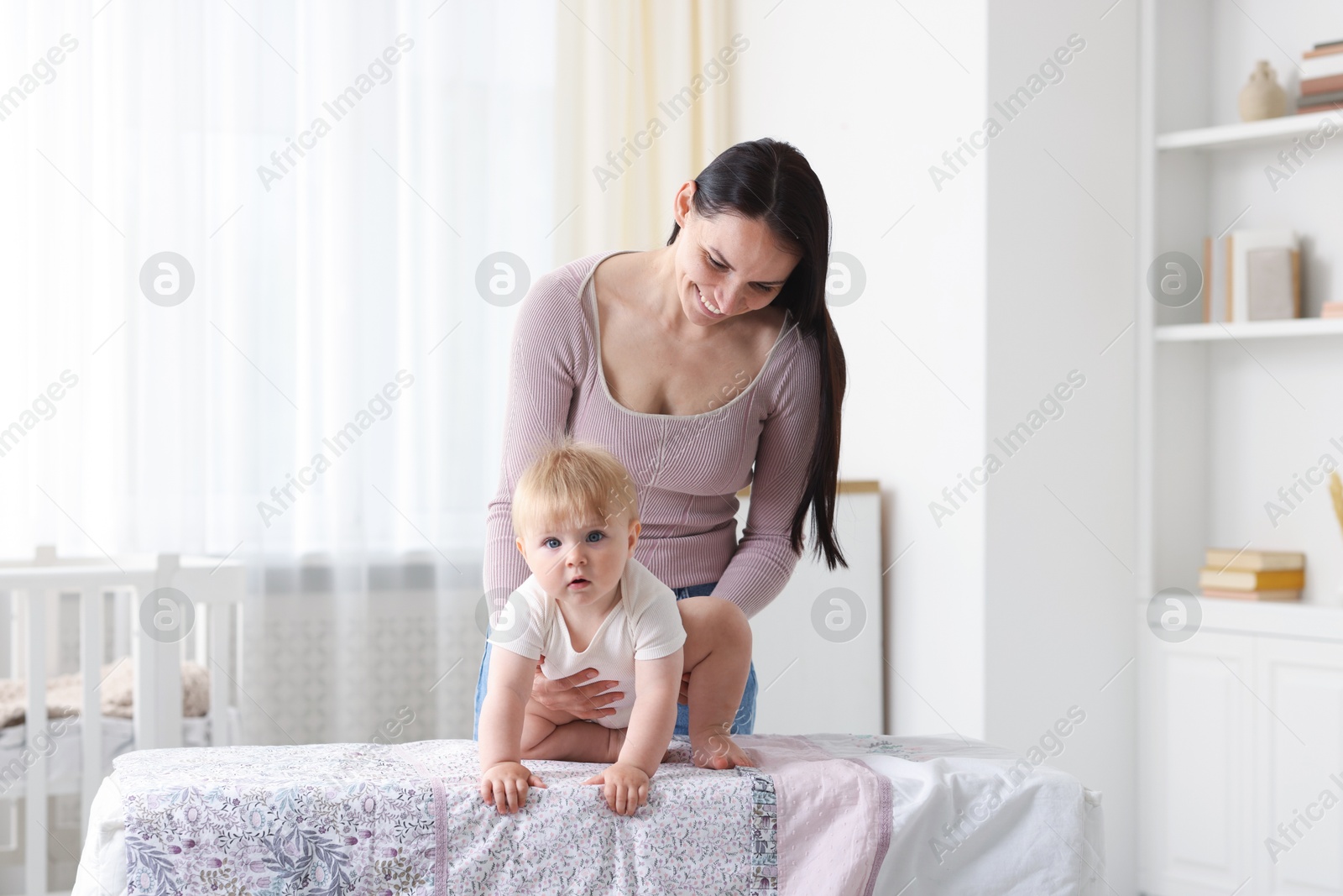 Photo of Mother with her cute baby at home