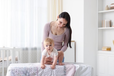Photo of Mother with her cute baby at home