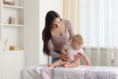 Photo of Mother with her cute baby at home