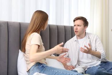 Photo of Woman and man fighting on bed at home