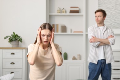 Photo of Woman and man having fight at home, selective focus