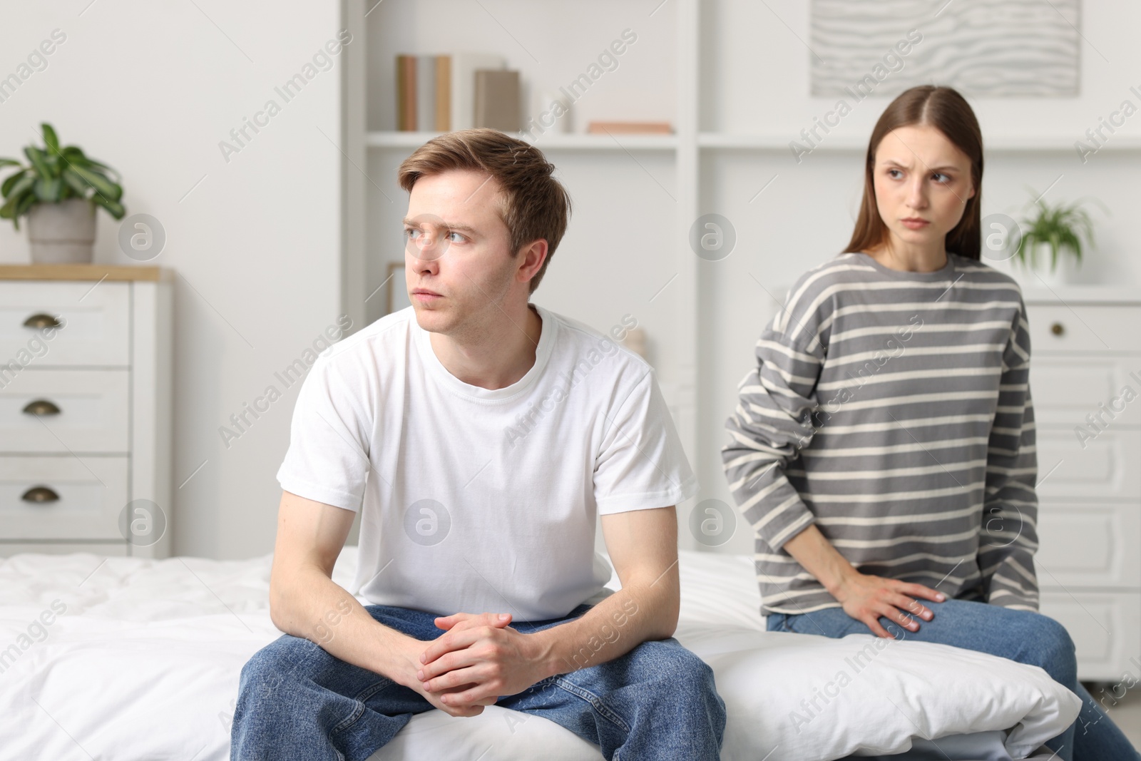 Woman and man having quarrel on bed at home Photo of Woman and man having quarrel on bed at home