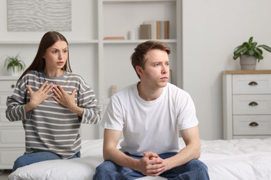 Photo of Woman and man fighting on bed at home