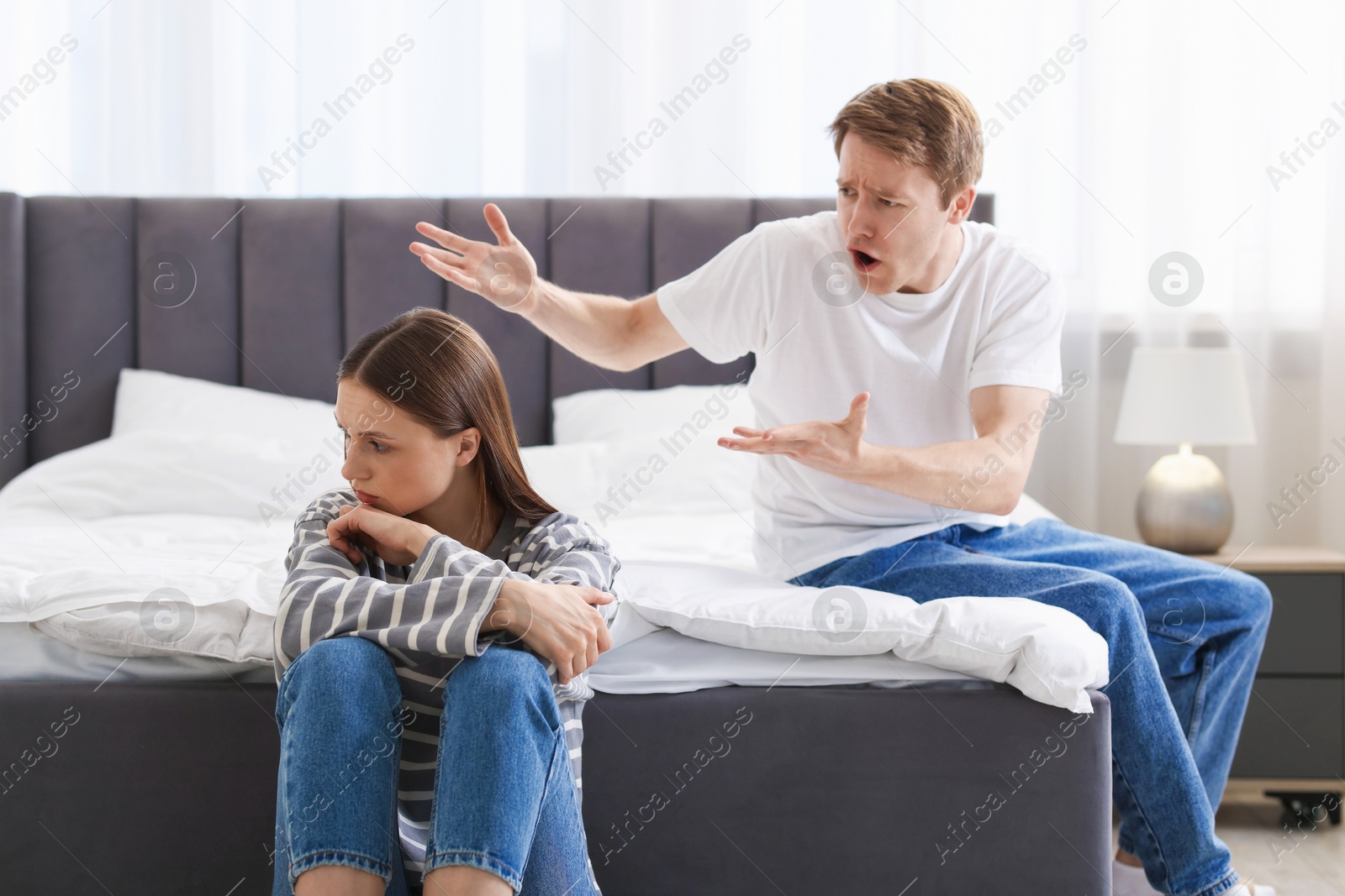 Photo of Woman and man having quarrel at home