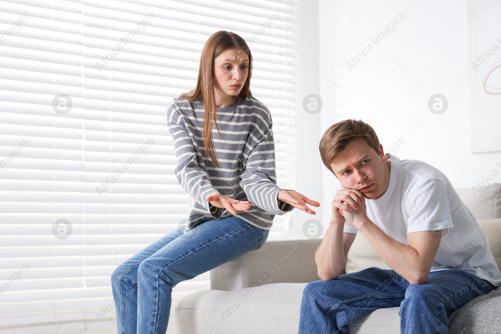 Woman and man having quarrel on sofa at home Photo of Woman and man having quarrel on sofa at home