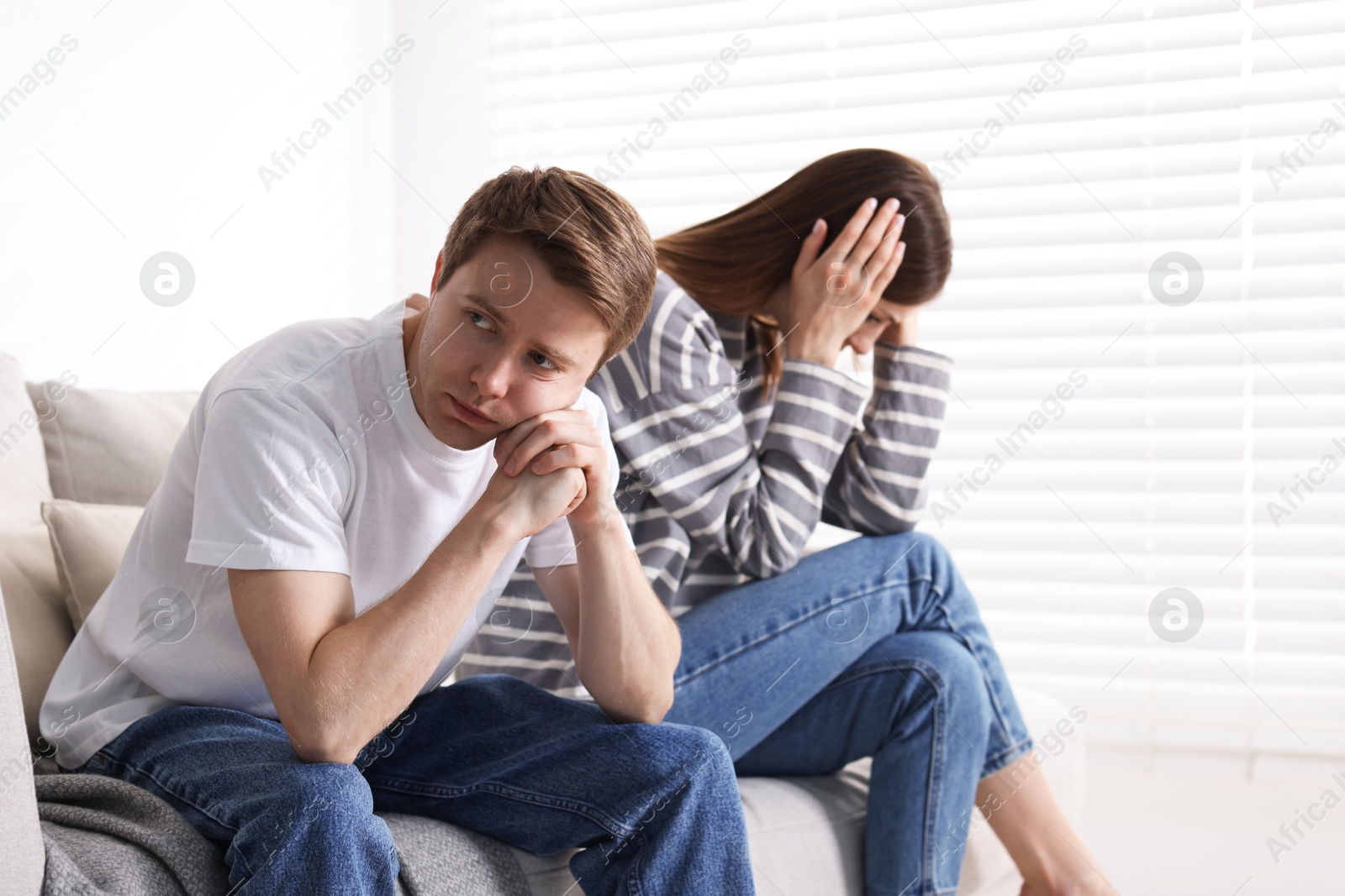 Woman and man having quarrel on sofa at home Photo of Woman and man having quarrel on sofa at home