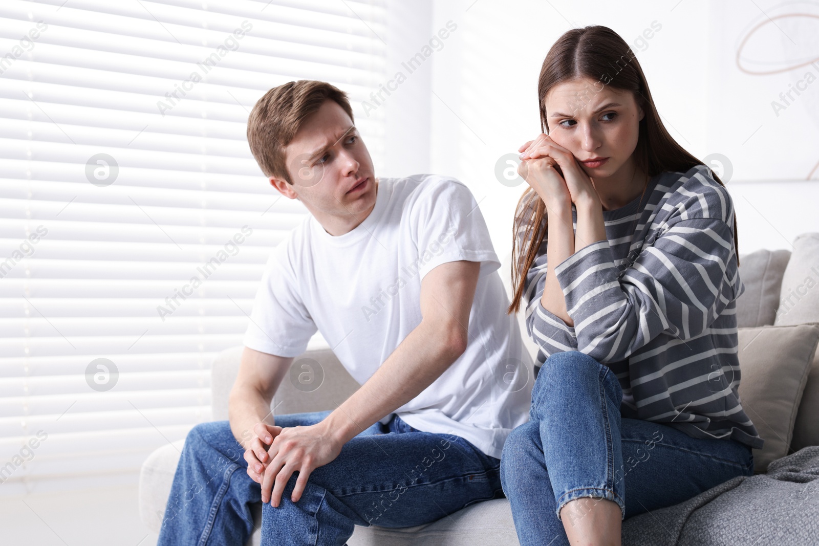 Woman and man having quarrel on sofa at home Photo of Woman and man having quarrel on sofa at home