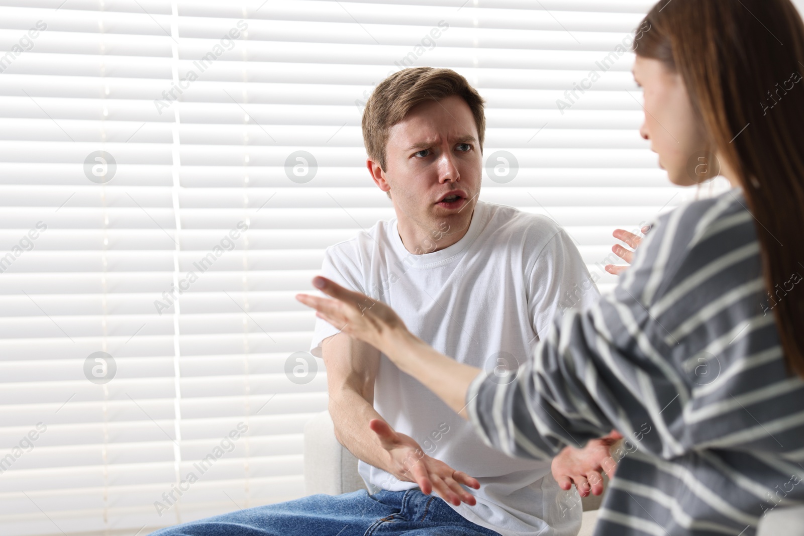 Woman and man having quarrel at home Photo of Woman and man having quarrel at home
