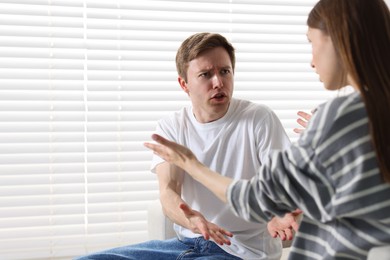 Photo of Woman and man having quarrel at home
