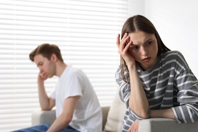 Photo of Woman and man having quarrel at home, selective focus