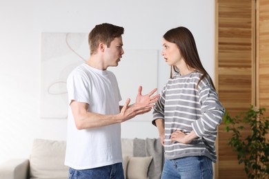 Photo of Woman and man having quarrel at home