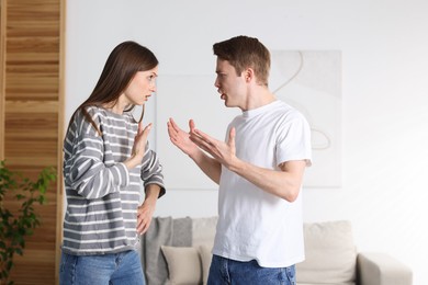Photo of Woman and man having quarrel at home
