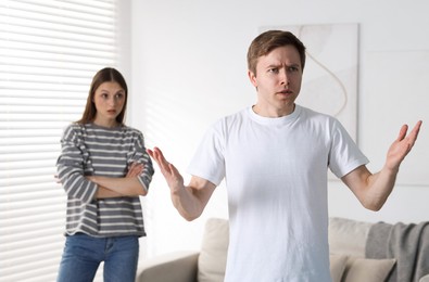 Photo of Woman and man having fight at home, selective focus