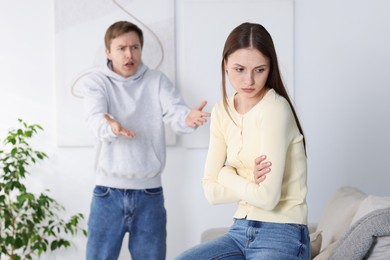 Photo of Woman and man having fight at home, selective focus