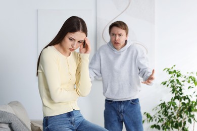 Photo of Woman and man having fight at home, selective focus