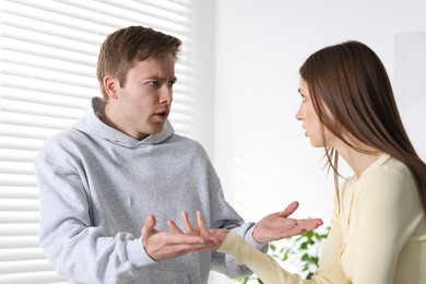 Photo of Woman and man having quarrel at home