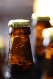Photo of Bottle of tasty beer on blurred grey background, macro view