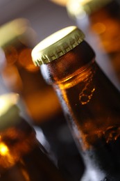 Photo of Bottle of tasty beer on blurred grey background, macro view