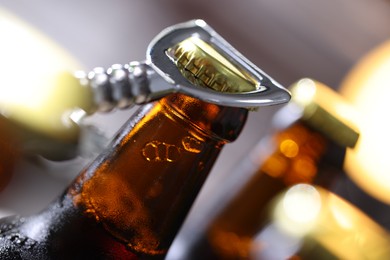 Photo of Opening bottle of beer on blurred grey background, closeup