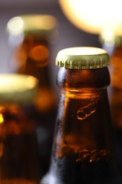 Photo of Bottle of tasty beer on blurred grey background, macro view