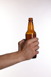 Photo of Man with bottle of tasty beer on white background, closeup
