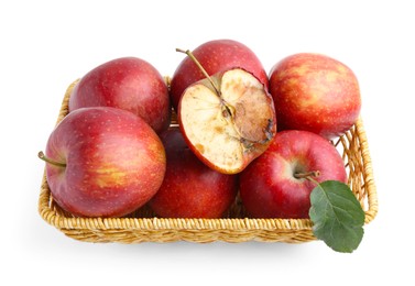 Photo of Spoiled apple and good ones in basket isolated on white