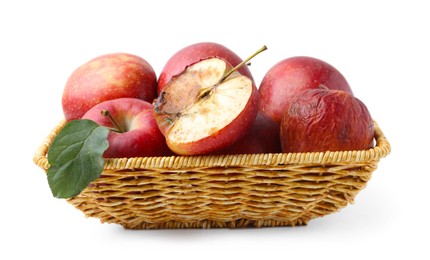 Photo of Spoiled apple and good ones in basket isolated on white