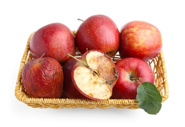Photo of Spoiled apple and good ones in basket isolated on white